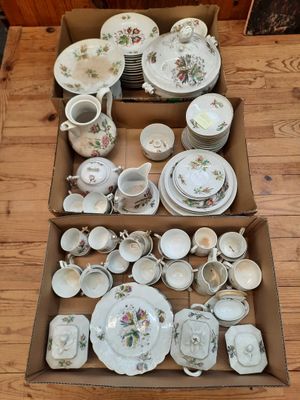 a box full of china on a wooden table