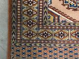 an image of a rug with fringes on the floor