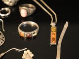 many different types of jewelry displayed on a table