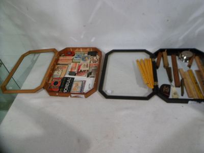 three trays with various items in them sitting on a table
