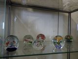a glass display case with a lot of glass fish bowls on it