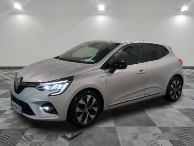 une voiture argentée est garée dans une pièce au sol en damier