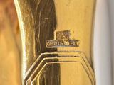 a close up of a gold ring with a cross on it