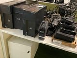 a lot of computer equipment sitting on a white shelf