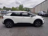 the white suv is parked on the side of the road in the parking lot