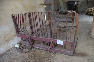 a metal bed in the middle of a dirty room