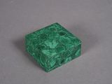 green marble box on a gray surface with a white background