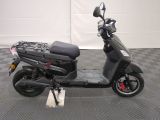 a scooter that is parked on a checkered floor