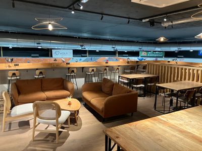 tables and chairs in a room with a lot of wooden furniture