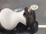 a close up of a horse ' s saddle on the ground