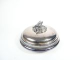 a silver plate with a silver object on top of it