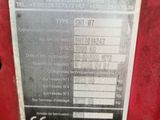 a close up of a metal plate on a red machine