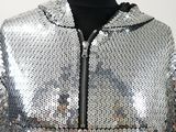 a close up of a silver sequinized jacket on a mannequin mannequin mannequin mannequin mannequin mannequin manne