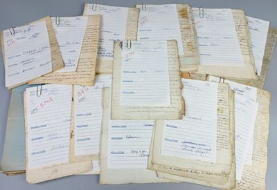 several old papers are stacked on top of each other on a table
