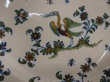a plate with a bird on it sitting on a table