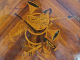a clock that is on the side of a wooden table