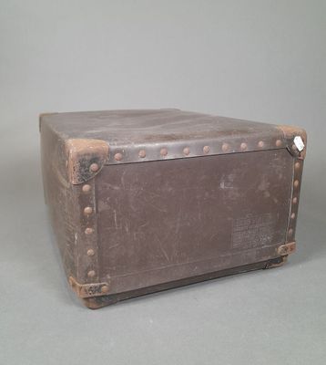 an old suitcase sitting on a table with a gray background