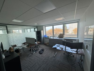 a room with a lot of chairs and a desk in it
