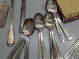 a lot of silver spoons and spoon spoons on a table