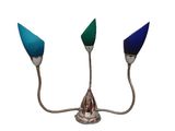 two blue and green glass lamps on a metal stand