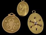 three gold medallions with a woman and a cross on them