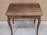 a small wooden table with a drawer on it