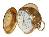 a gold pocket watch that is open on a white background
