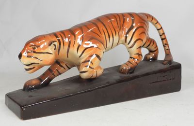 figurine of a tiger on a wooden base on a white background