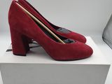 a pair of red heels on a white box