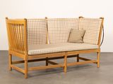 a wooden bench with a cushion on it in a room