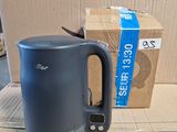 a blue kettle sitting on top of a cardboard box