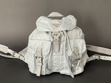 white leather backpack with straps on a black surface