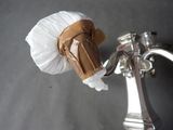 a piece of chocolate on the handle of a faucet