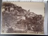 an old photo of a town on a hill