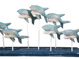 a wooden sculpture of a group of sharks on a stand