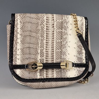 a white and black snake skin purse with gold hardware