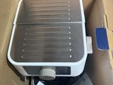 a box with a toaster inside of it on the floor
