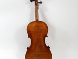an old violin sitting on top of a white surface