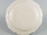 underside view of a white bowl with a blue decoration on the rim