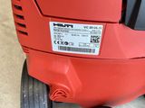 a close up of a red and black blower sitting on top of a floor
