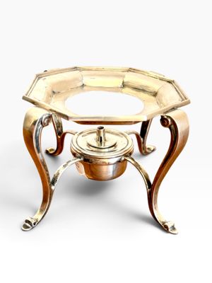 an image of a brass plate on a stand on a white background