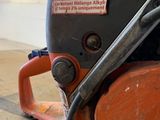 an orange and black machine sitting on top of a hard wood floor