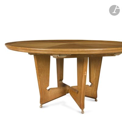 a close up of a wooden table with two legs and a round top