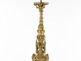 an ornate brass candle holder with a green top