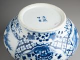 a blue and white vase sitting on a table