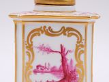a pink and gold jar with a picture of a boat on it