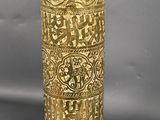 a gold vase that is sitting on a table