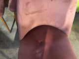 two pink chairs with a price tag on the back of them