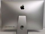 a silver apple computer sitting on a white table