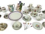 many different types of tea cups and saucers on the table
